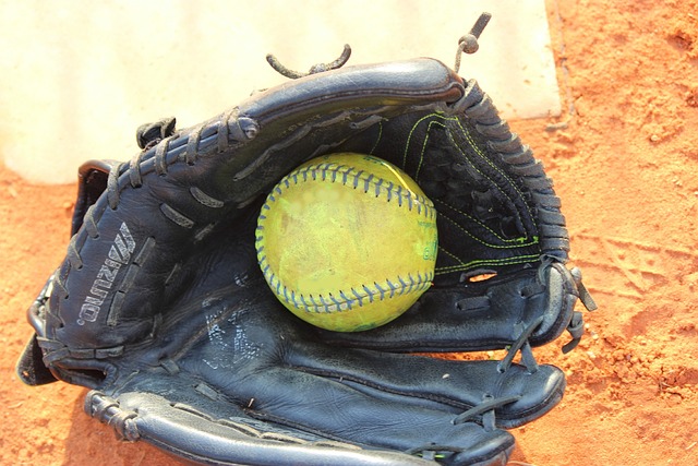 A glove holding a softball.