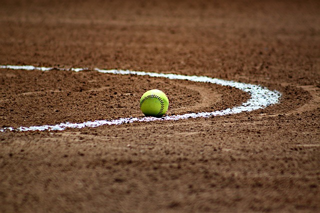 A softball field with a ball in the middle.