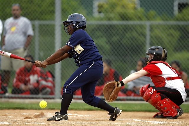 Fastpitch batter missing the ball.
