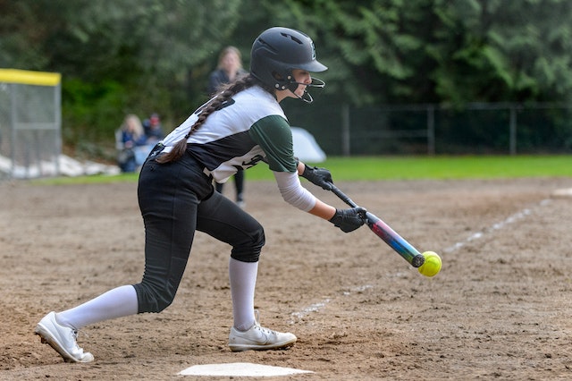 A fastpitch player bunting.
