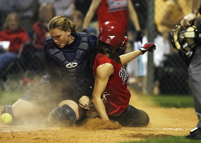 Softball player attempting to steal a base.